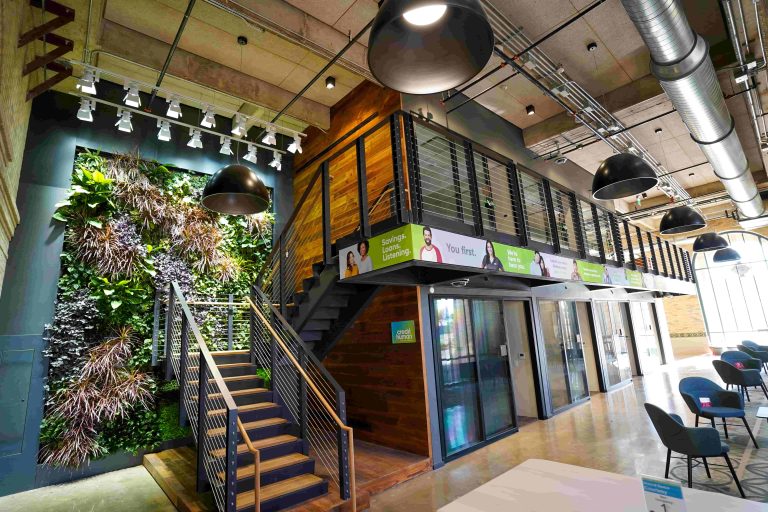 Interior view of Credit Human’s headquarters showing plant‑covered "living walls."