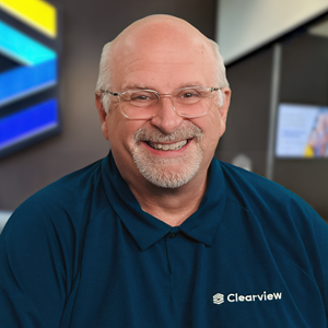 Raymond George, chief information officer at Clearview FCU, smiles at the camera while wearing a navy Clearview FCU polo shirt.